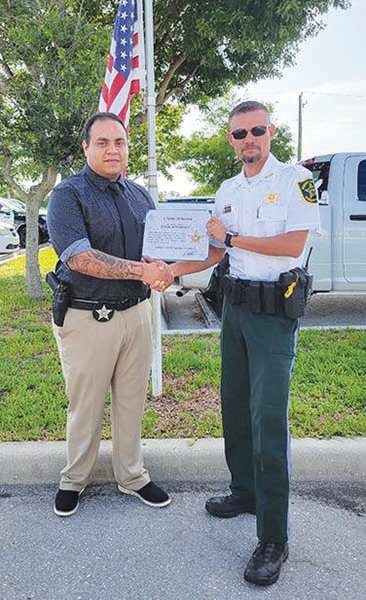 Hendry County Sheriff's Office Lieutenant Allen K. Hudson (left) presented Detective Sergio Bustamante with his Five Years of Service Award.